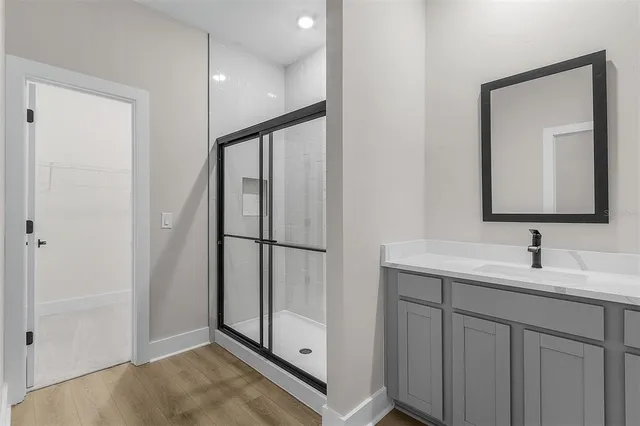 a bathroom with a double vanity sink and mirror