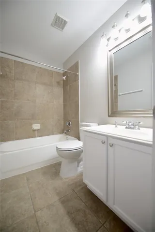 a bathroom with a toilet a sink a mirror and bathtub