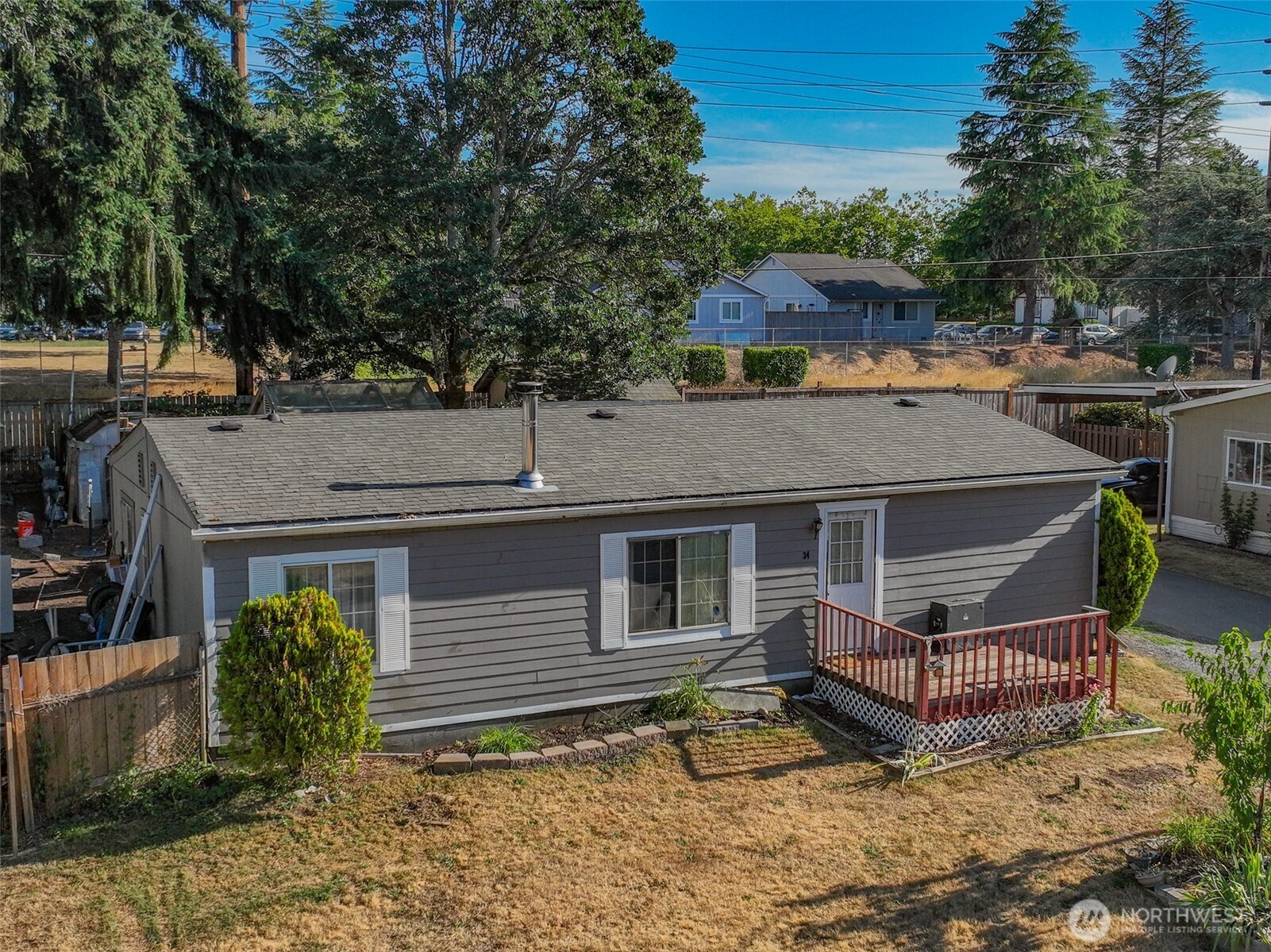 510 Duterrow Road Southeast, Unit 34 Olympia, WA 98513 - Photo 2 of 20 a view of a house with a wooden deck and a tree