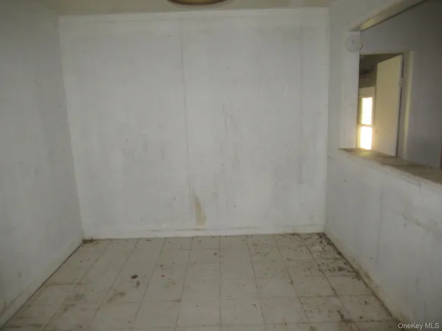 an empty room with white walls