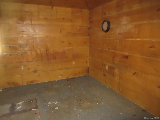 an empty room with closet and a chandelier fan