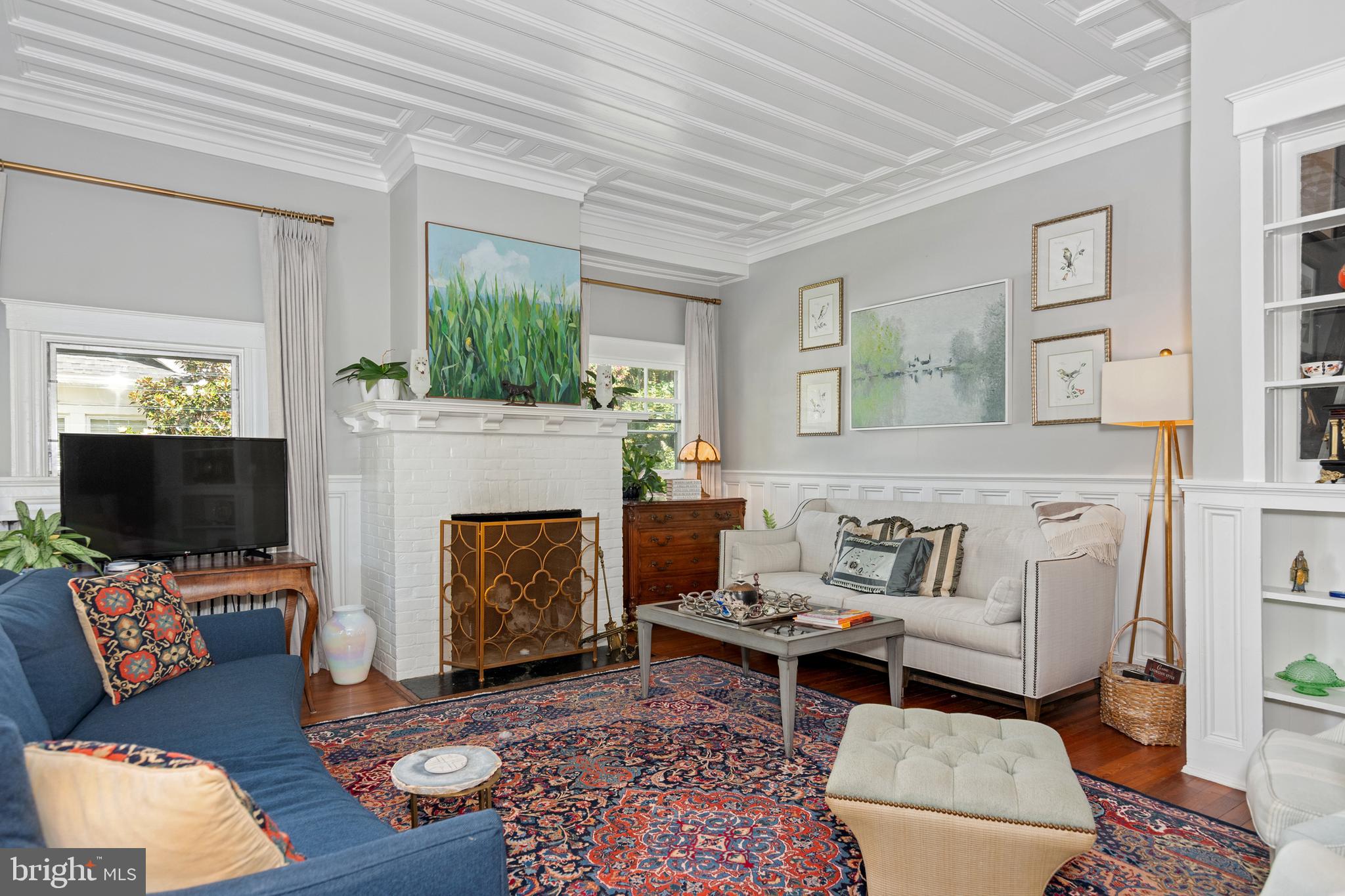 306 Oakley Street Cambridge, MD 21613 - Photo 16 of 35 a living room with furniture a flat screen tv and a fireplace