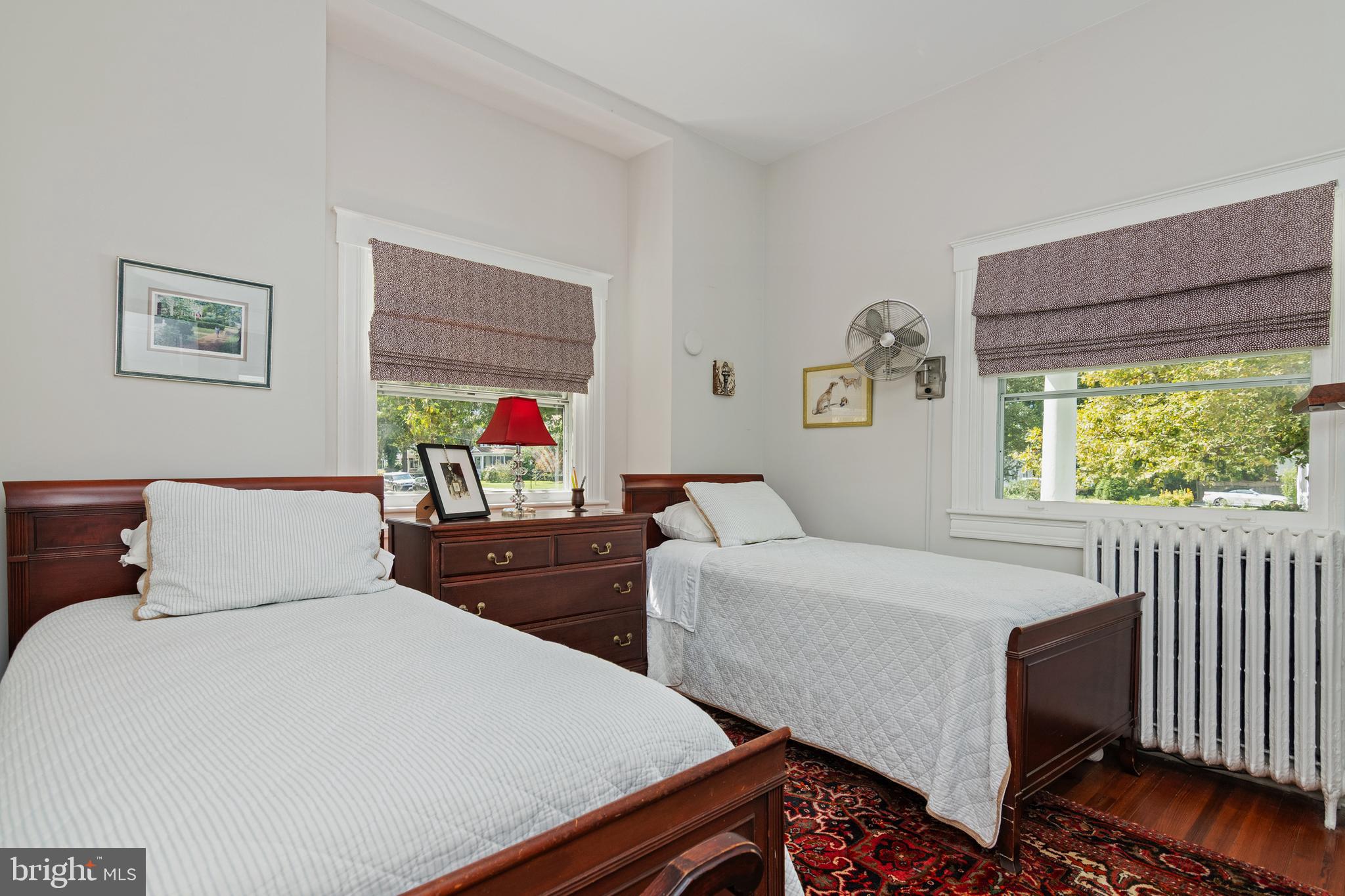 306 Oakley Street Cambridge, MD 21613 - Photo 21 of 35 a bedroom with two beds and a dresser