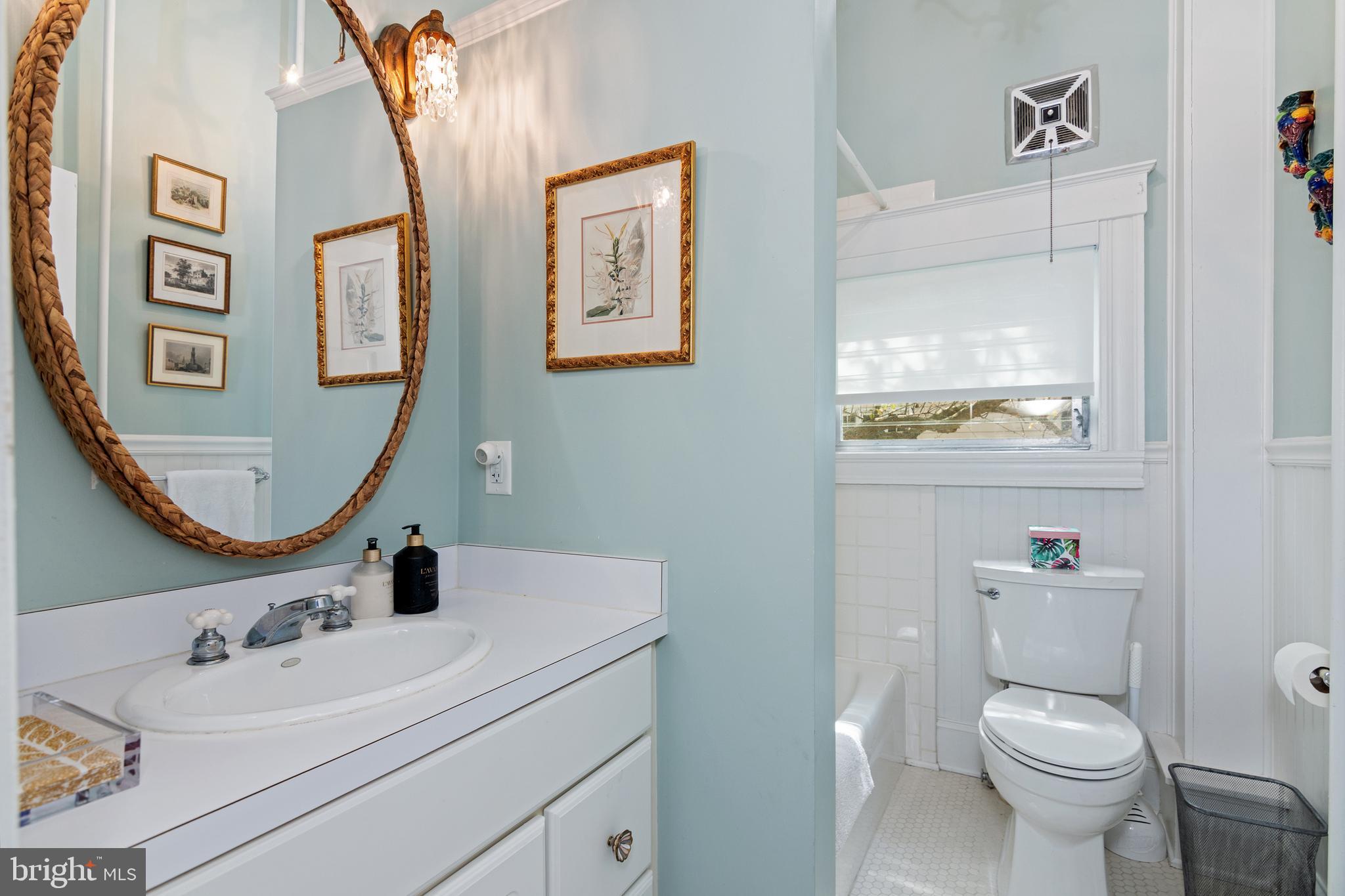 306 Oakley Street Cambridge, MD 21613 - Photo 22 of 35 a bathroom with a toilet sink and mirror
