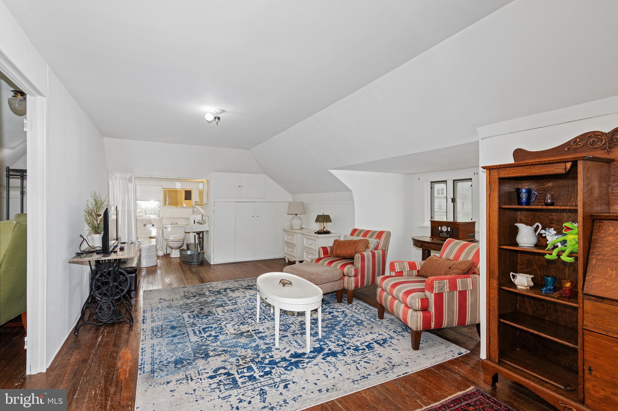 306 Oakley Street Cambridge, MD 21613 - Photo 28 of 35 a living room with furniture a table and bookshelf