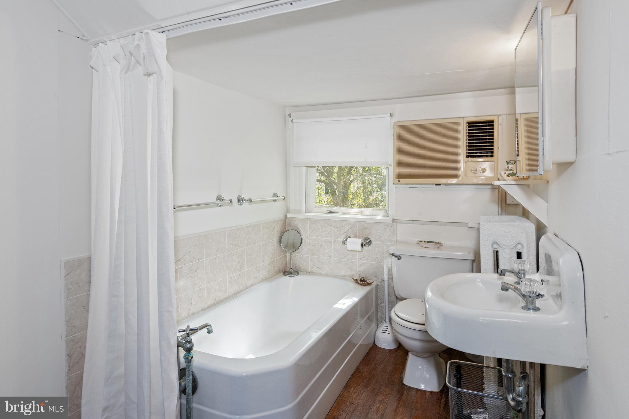 306 Oakley Street Cambridge, MD 21613 - Photo 29 of 35 a bathroom with a sink and a mirror