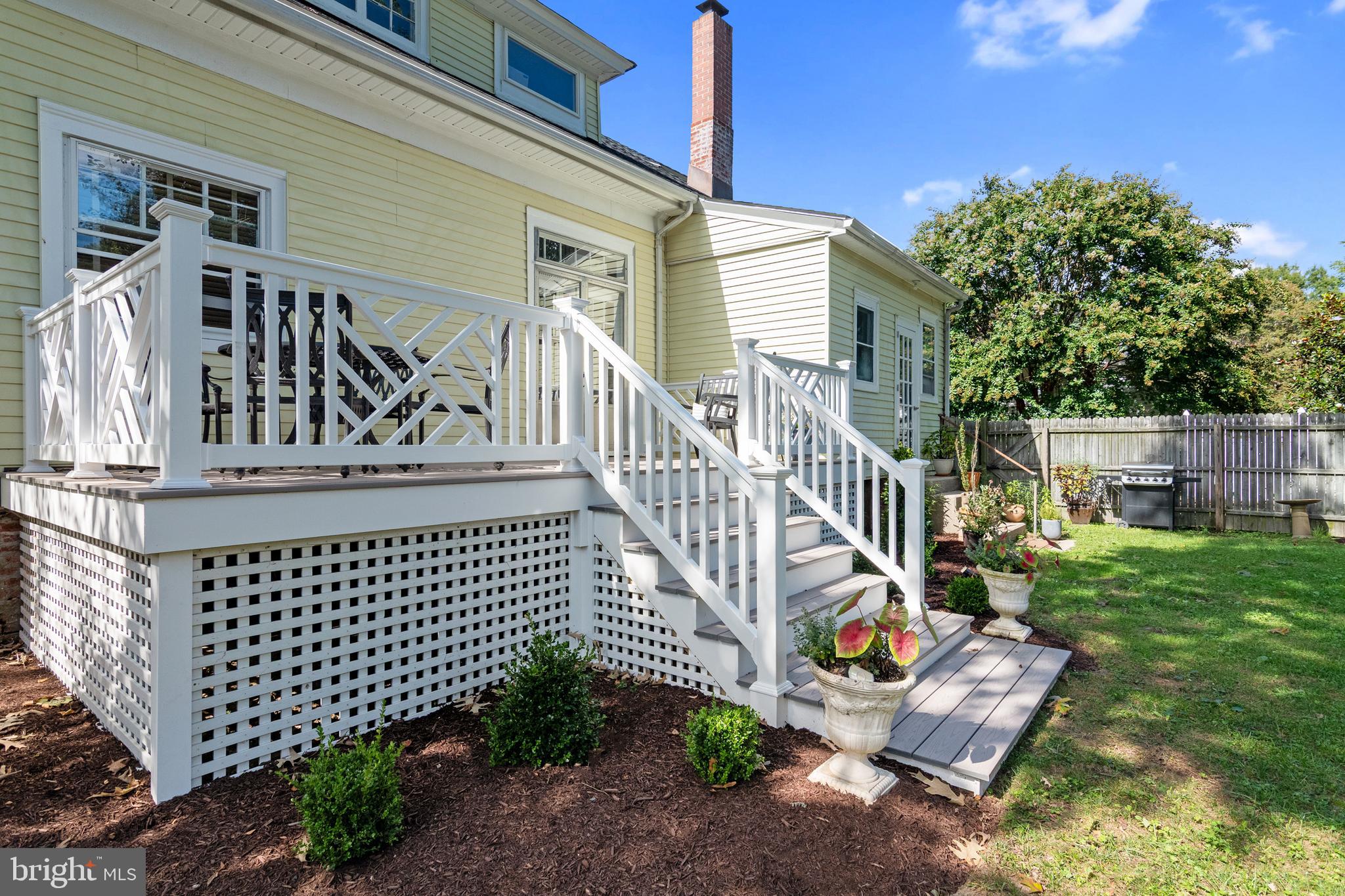 306 Oakley Street Cambridge, MD 21613 - Photo 6 of 35 a view of a house with a small yard and wooden fence