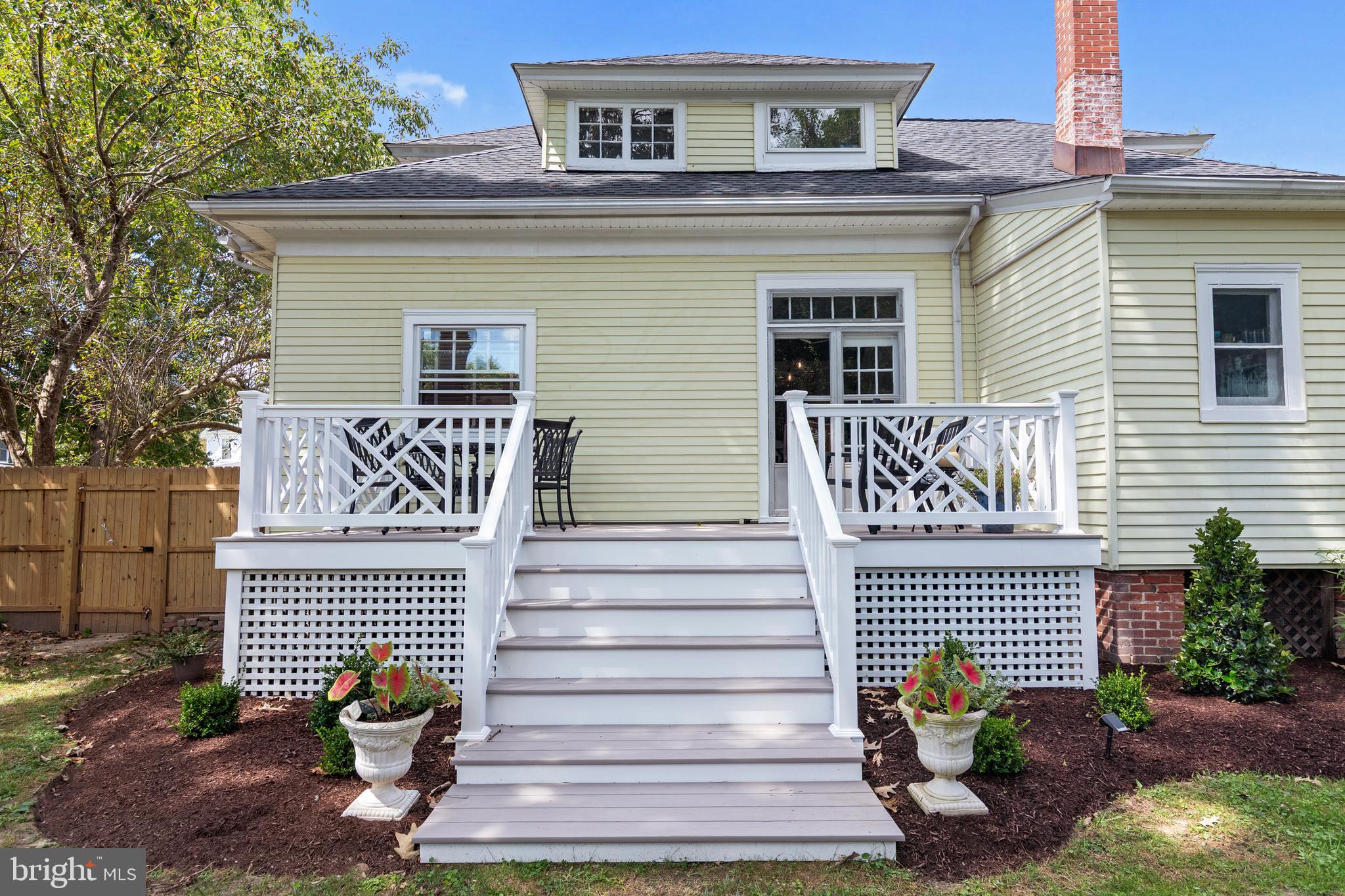 306 Oakley Street Cambridge, MD 21613 - Photo 10 of 35 a view of a house with a yard and a floor to ceiling window