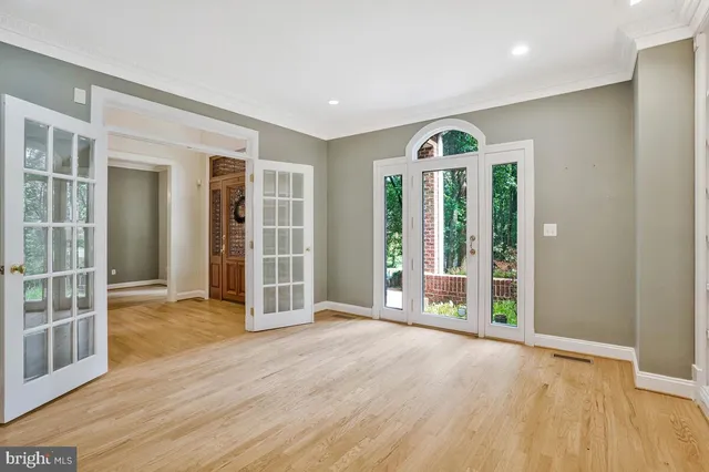 a dining room with furniture a chandelier and wooden floor