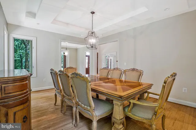 a kitchen with granite countertop a stove and a wooden floor