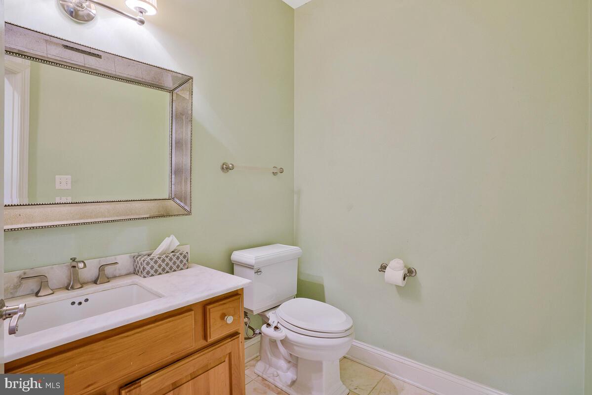 502 Seneca Knoll Court Great Falls, VA 22066 - Photo 20 of 56 a bathroom with a sink a toilet and mirror