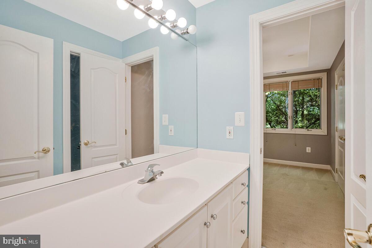 502 Seneca Knoll Court Great Falls, VA 22066 - Photo 23 of 56 a bathroom with a sink and a mirror