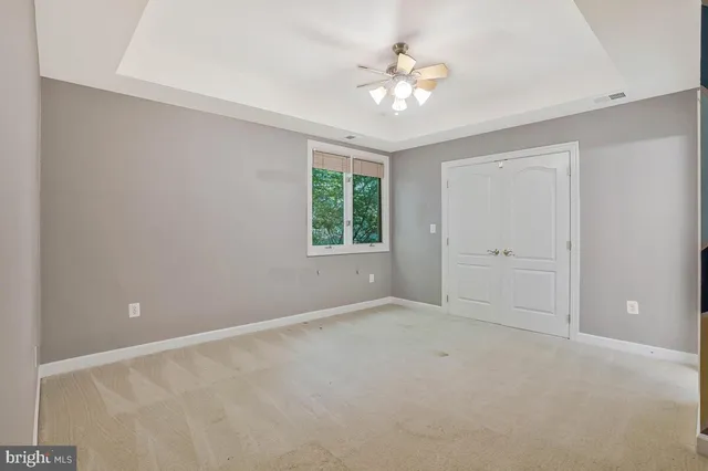 a view of a livingroom with a ceiling fan and window