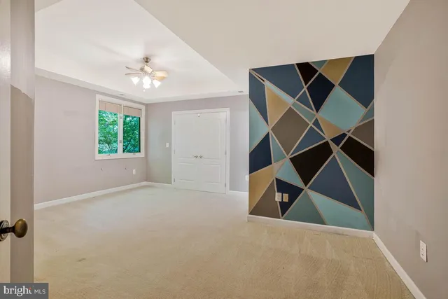 a view of an empty room with a fireplace and a window