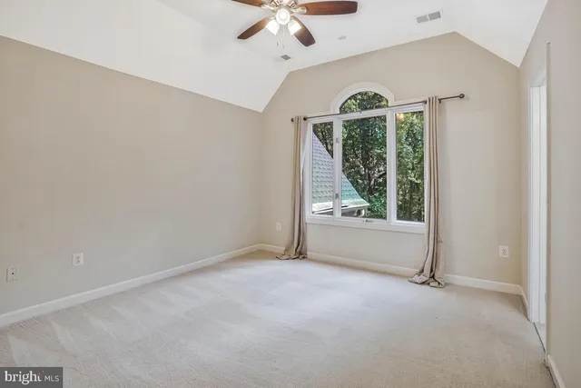 a view of an empty room with stairs and ventilation