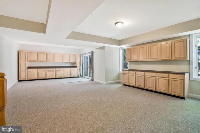 a view of a house with backyard and a tree