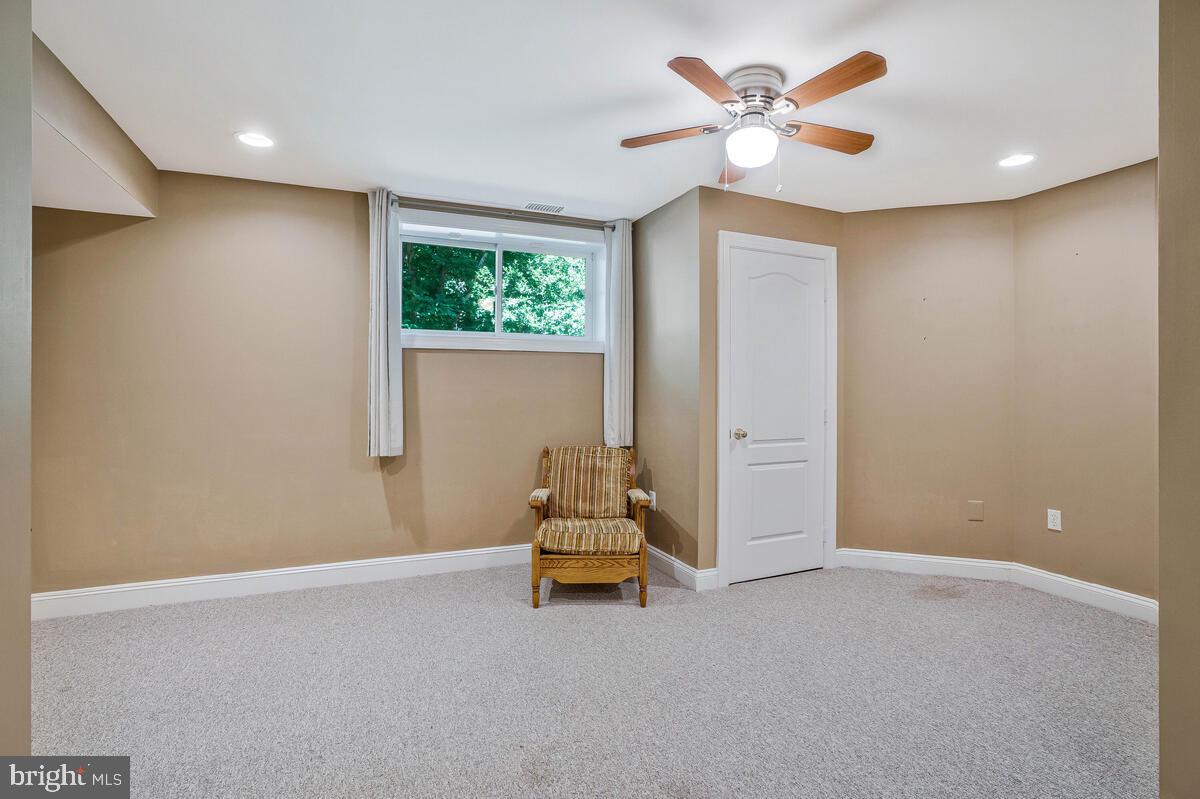 502 Seneca Knoll Court Great Falls, VA 22066 - Photo 45 of 56 a living room with furniture and a large window