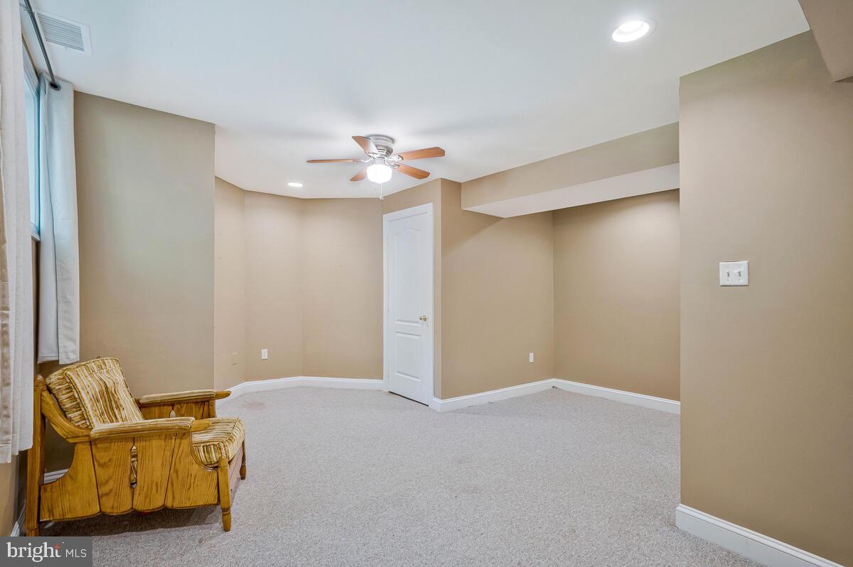 502 Seneca Knoll Court Great Falls, VA 22066 - Photo 46 of 56 a furnished livingroom with a ceiling fan