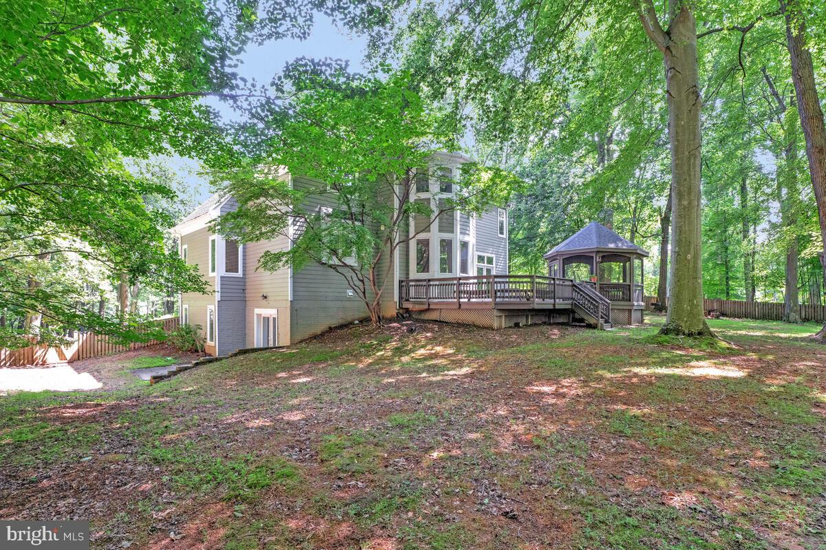 502 Seneca Knoll Court Great Falls, VA 22066 - Photo 48 of 56 a view of a house with backyard and a tree