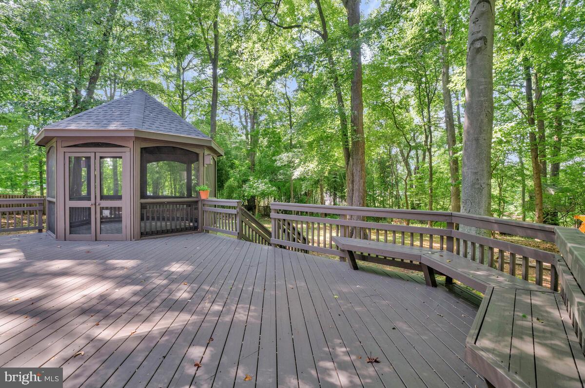 502 Seneca Knoll Court Great Falls, VA 22066 - Photo 55 of 56 a view of a deck with couches wooden floor and fence