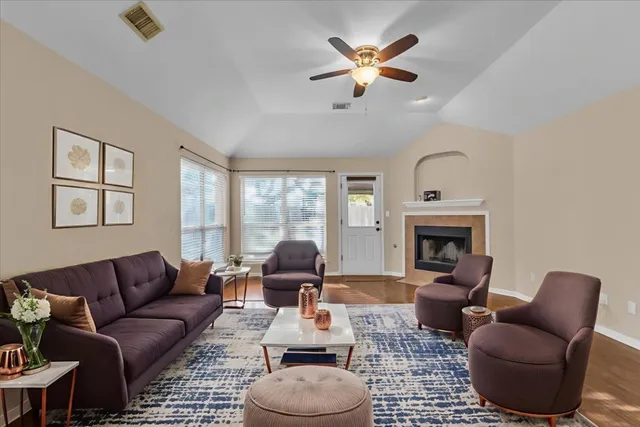 a view of a livingroom with a fireplace and wooden floor