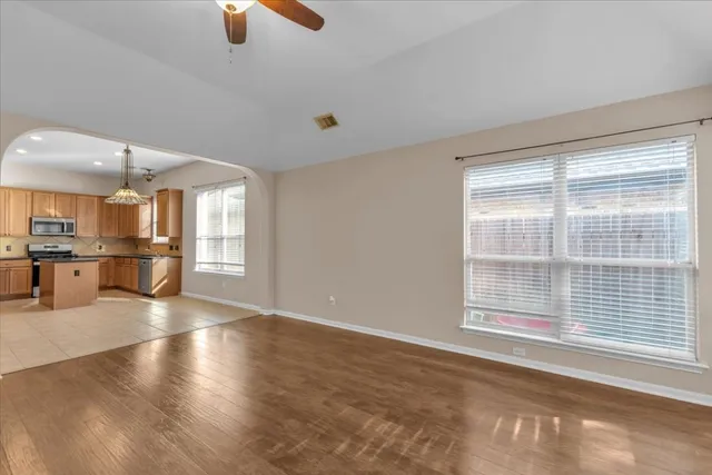 a spacious bathroom with a tub sink and mirror
