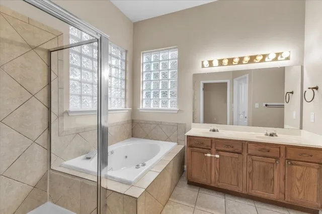 a bathroom with a double vanity sink toilet mirror and shower