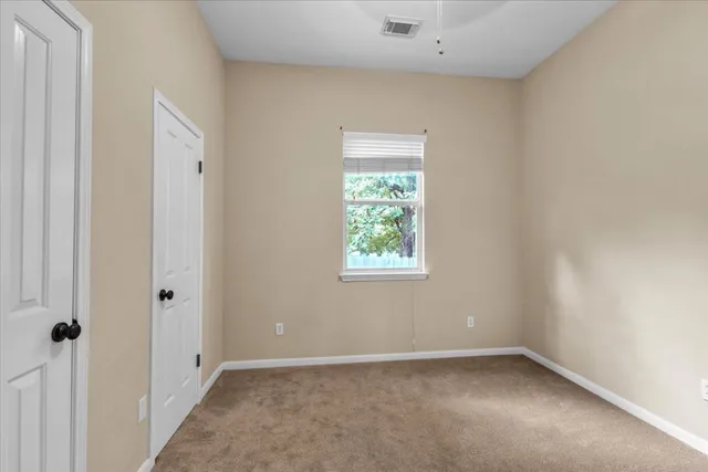 a view of a big room with closet and windows