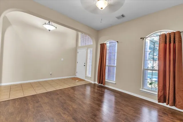 wooden floor in an empty room with a window