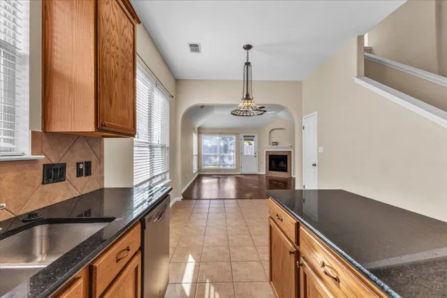 a dining room with furniture a chandelier and window