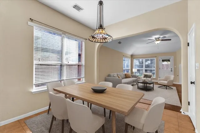 a living room with furniture a fireplace and a chandelier
