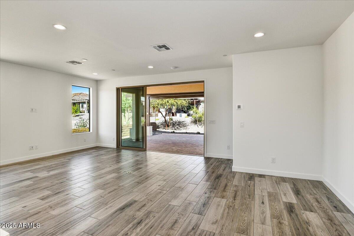 18230 East Coronado Cave Court Rio Verde, AZ 85263 - Photo 13 of 49 an empty room with wooden floor and windows