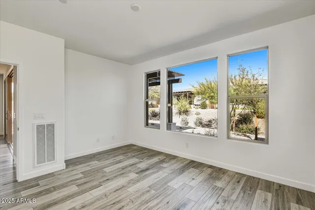 a view of a room with wooden floor and window