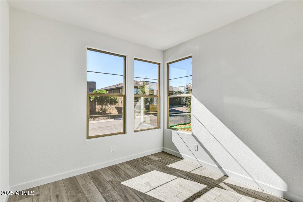 18230 East Coronado Cave Court Rio Verde, AZ 85263 - Photo 21 of 49 a view of an empty room with wooden floor and a window