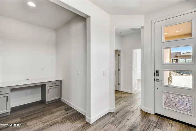 a view of an entryway with wooden floor