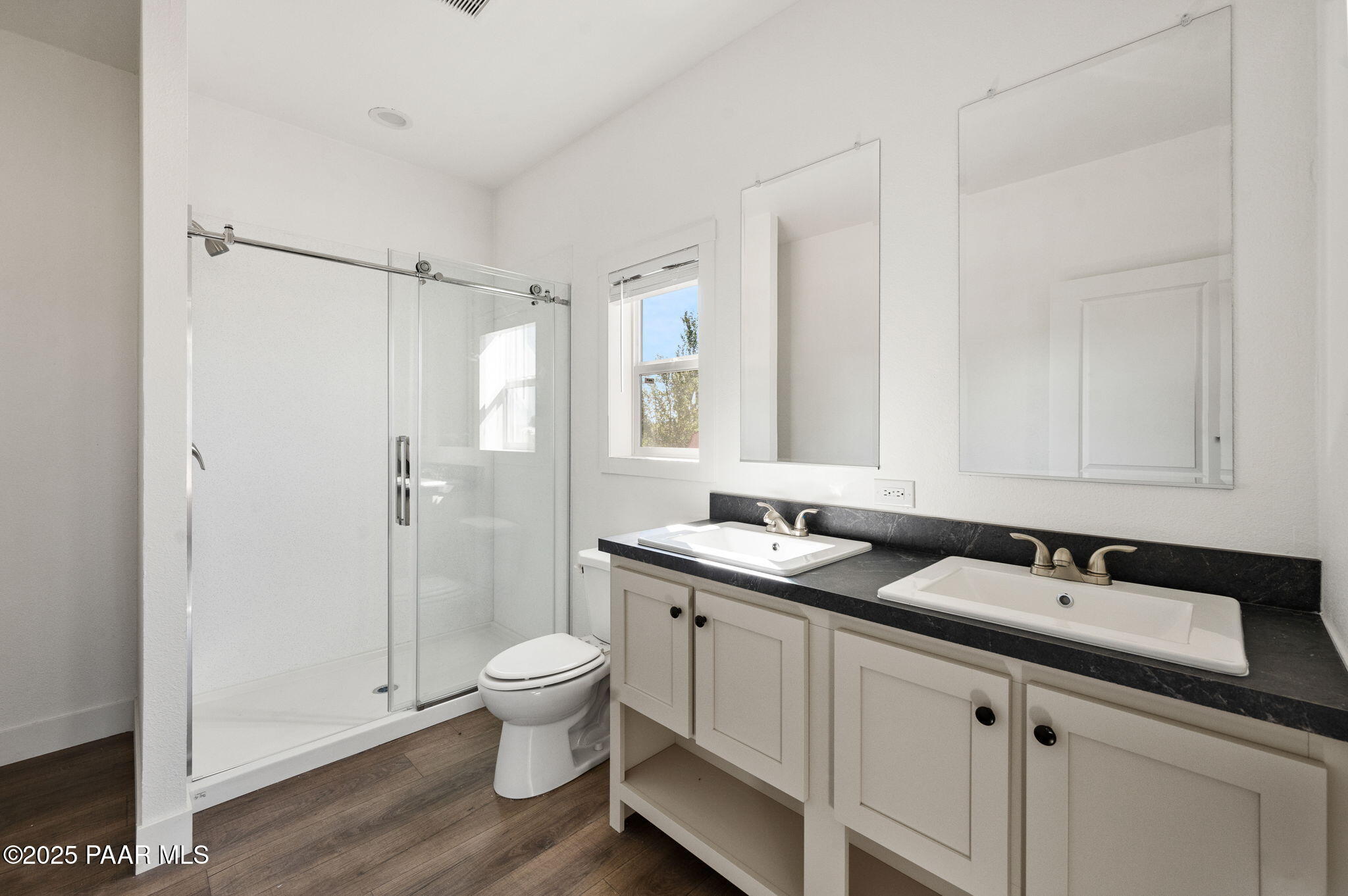 39 East Abra Road Paulden, AZ 86334 - Photo 15 of 23 a bathroom with a granite countertop sink toilet a mirror a vanity and shower