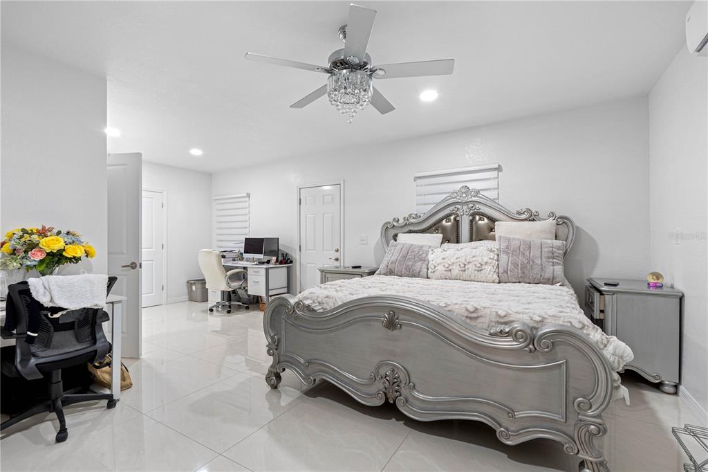 14450 Lancer Road Spring Hill, FL 34610 - Photo 33 of 46 a bedroom with a bed furniture and a chandelier