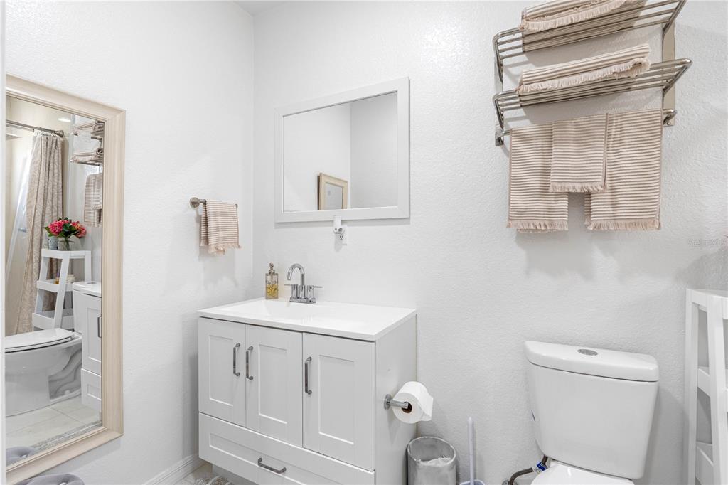 14450 Lancer Road Spring Hill, FL 34610 - Photo 35 of 46 a bathroom with a toilet a sink and a mirror