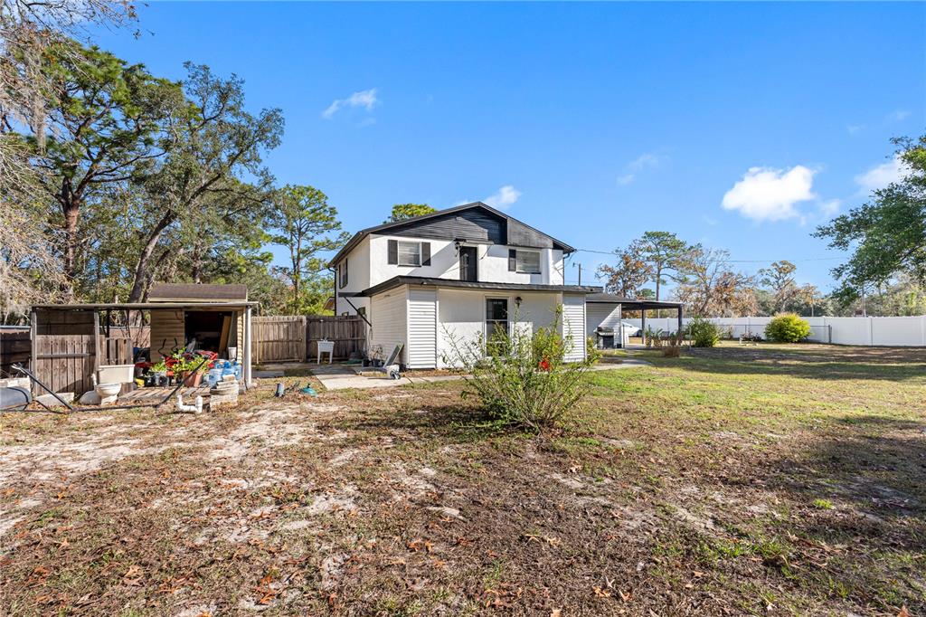 14450 Lancer Road Spring Hill, FL 34610 - Photo 41 of 46 a front view of a house with a yard