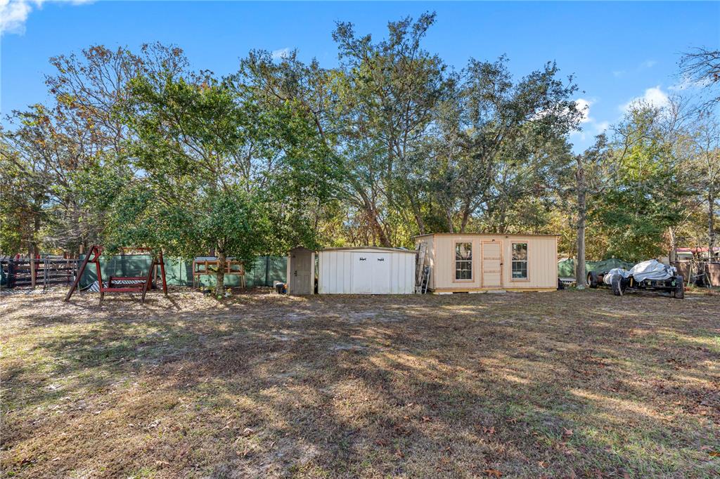 14450 Lancer Road Spring Hill, FL 34610 - Photo 42 of 46 a view of a house with a yard