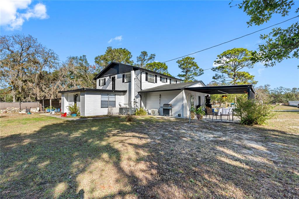 14450 Lancer Road Spring Hill, FL 34610 - Photo 6 of 46 front view of a house with a big yard