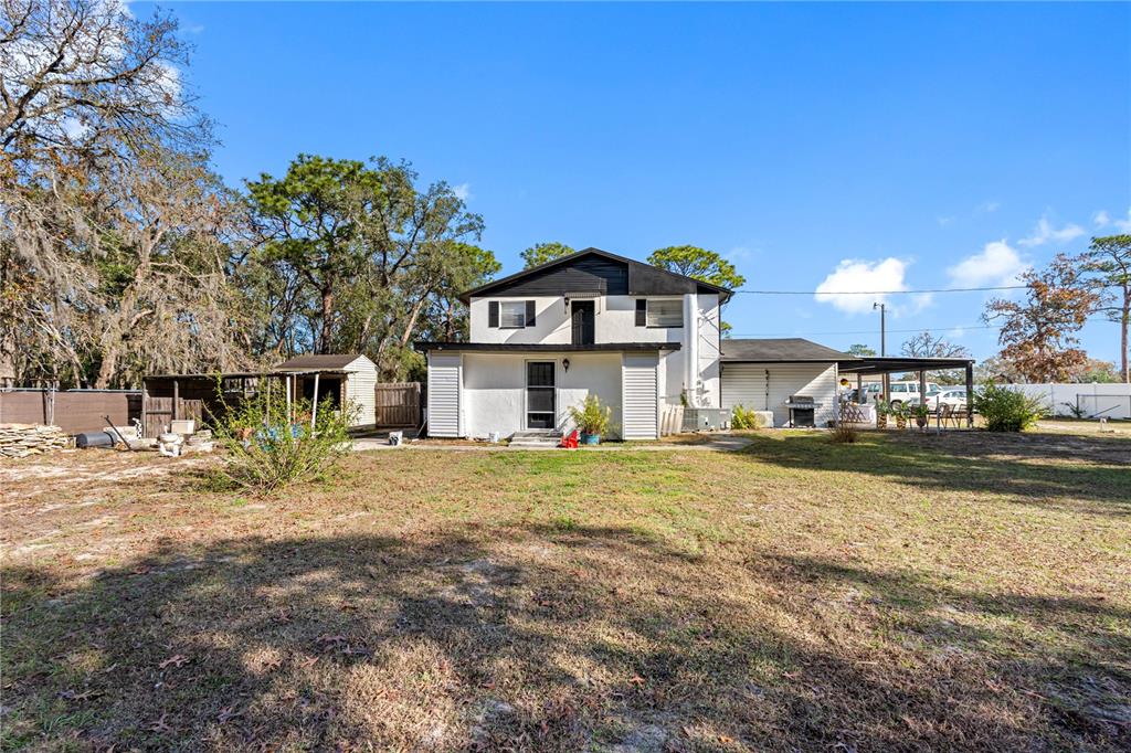 14450 Lancer Road Spring Hill, FL 34610 - Photo 7 of 46 a view of a house with a yard