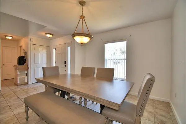 a dining room with furniture and wooden floor