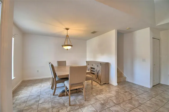 a view of a kitchen with kitchen island a sink wooden floor and a living room