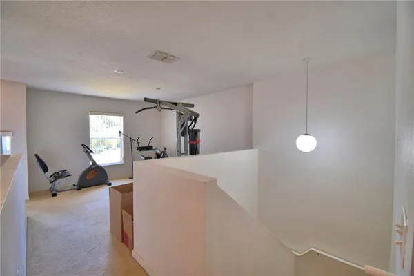 a view of a kitchen with kitchen island a sink wooden floor and a living room