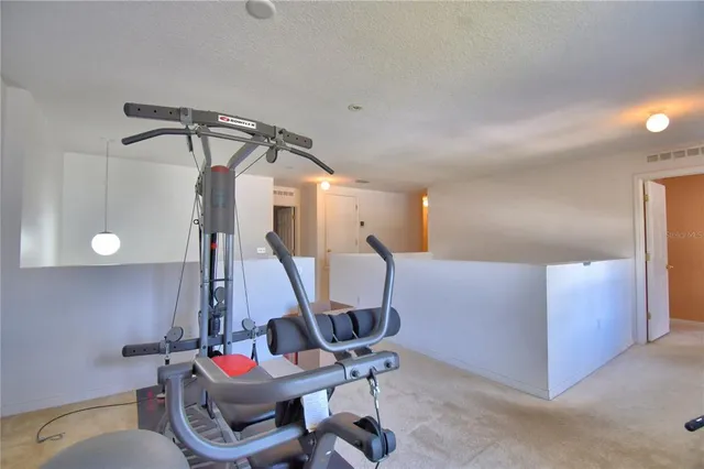 a bedroom with a large bed and a flat tv screen on dresser