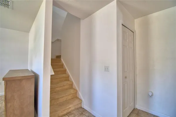 a kitchen with stainless steel appliances kitchen island granite countertop a refrigerator a sink and a stove