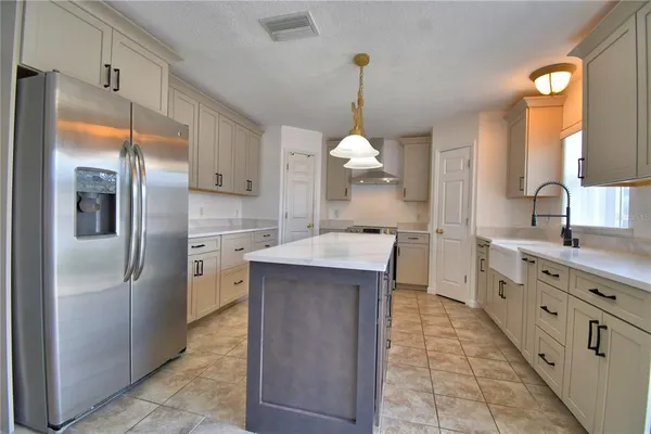 a living room with furniture flower pot and a chandelier