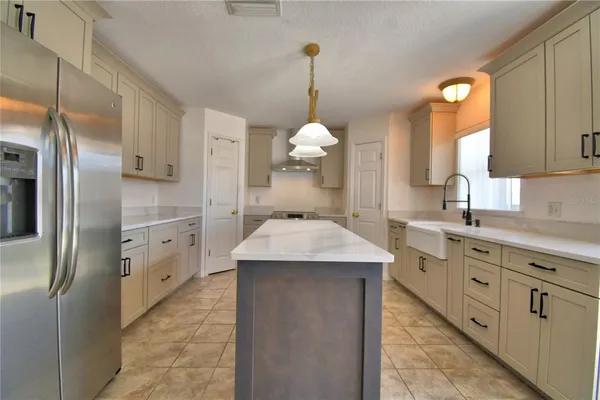 a kitchen with stainless steel appliances granite countertop a stove and a refrigerator