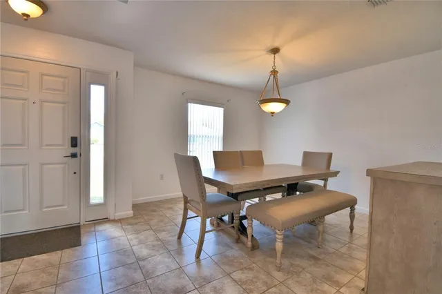 a view of a dining room with a table and chairs